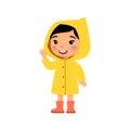 Little asian girl in a yellow raincoat smiles and waves a hand. Female child standing cartoon character. Royalty Free Stock Photo