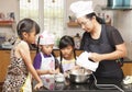 Little asian girls and mother making sponge cake Royalty Free Stock Photo