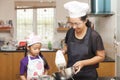 Little asian girls and mother making sponge cake Royalty Free Stock Photo