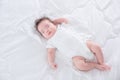 Infant sleeping on white bed in the morning Royalty Free Stock Photo