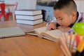 little asian kid boy child children studying reading book Royalty Free Stock Photo