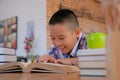 little asian kid boy child children studying reading book Royalty Free Stock Photo