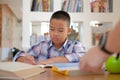 little asian kid boy schoolboy writing drawing on notebook. child children doing homework. Royalty Free Stock Photo