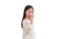 Little asian kid girl bite red apple isolated over white background Royalty Free Stock Photo