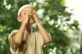 Little asian muslim child in traditional dress praying