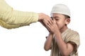 Little asian muslim kid in white cap kissing parents hand Royalty Free Stock Photo