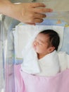 The little Asian newborn baby sleeping on a bed in hospital Royalty Free Stock Photo