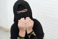 Little Asian Pakistani Muslim girl wearing black hijab with beautiful eyes is praying to god. Royalty Free Stock Photo