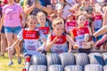 little athletes start in children`s races to overcome obstacles. Text in Russian: race of heroes, children`s start Royalty Free Stock Photo