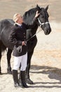 A little attention goes a long way. High angle shot of a young female rider stroking her horse affectionately. Royalty Free Stock Photo