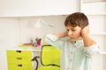 Autistic boy with sad look close ears from noise Royalty Free Stock Photo