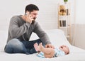 Little babby suffering from colic, dad calling to doctor