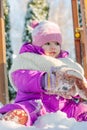 Little babe girl playing on the winter playground. Royalty Free Stock Photo