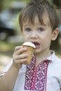 Little baby with big blue eyes eats ice cream Royalty Free Stock Photo