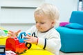 Baby girl playing toy cars