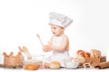 Little baby boy baker enjoying making and eating food. Little baker baby boy Royalty Free Stock Photo