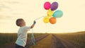 little baby boy with balloons. happy family a birthday kid dream concept. baby son holding balloons against a blue sky Royalty Free Stock Photo