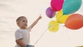 little baby boy with balloons. happy family a birthday kid dream concept. baby son holding lifestyle balloons against a Royalty Free Stock Photo