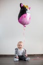 Little baby boy with big balloon, sitting on the floor Royalty Free Stock Photo