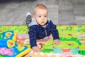 Little baby boy crawling on the floor at home. A nine-month-old boy with blond hair and blue eyes Royalty Free Stock Photo