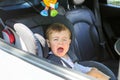 Little baby boy is crying in his car seat not willing to sit in it. Royalty Free Stock Photo