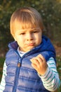 Little baby boy eating biscuit or cookies in autumn park Royalty Free Stock Photo