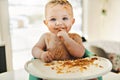 Little baby boy eating her dinner and making a mess Royalty Free Stock Photo