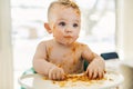 Little baby boy eating her dinner and making a mess Royalty Free Stock Photo