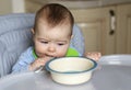 Little baby boy eating in his feeding chair Royalty Free Stock Photo
