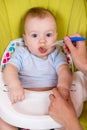 Little baby boy feeding with a spoon Royalty Free Stock Photo