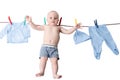 Little baby boy hanging on a clothesline, drying on clothespins on rope after laundry isolated