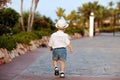 Little baby boy in a hat and shorts goes ahead in summer, view f Royalty Free Stock Photo