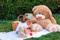 Little baby boy having picnic with teddy toys in garden Royalty Free Stock Photo