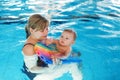 Little baby boy and his mother learning to swim in an indoor swimming pool Royalty Free Stock Photo