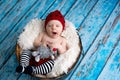 Little baby boy with knitted hat in a basket, happily smiling Royalty Free Stock Photo