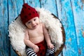 Little baby boy with knitted hat in a basket, happily smiling Royalty Free Stock Photo