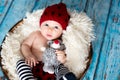 Little baby boy with knitted hat in a basket, happily smiling Royalty Free Stock Photo