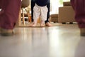 Little baby boy learning to walk with mother help at home Royalty Free Stock Photo