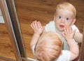 Little baby boy in mirror reflection