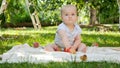 Little baby boy picking ripe apples under apple tree at backyard garden. Concept of child development, parenting and Royalty Free Stock Photo