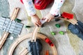 Little baby boy playing with colorful wooden train on the carpet Royalty Free Stock Photo