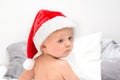 Little baby boy with red santa hat portrait. One year old kid in christmas costume looking back. Christmas time concept Royalty Free Stock Photo
