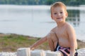 Little baby boy is resting on the sandy shore, build a castle Royalty Free Stock Photo