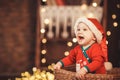 Little Baby Boy in Santa hat sitting in a wicker basket Royalty Free Stock Photo