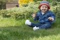 Little baby boy sitting on the grass outdoors Royalty Free Stock Photo