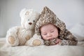 Little baby boy , sleeping at home with soft teddy bear toys Royalty Free Stock Photo