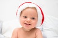 Little baby boy smiling face with red santa hat. One year old kid in christmas costume Royalty Free Stock Photo