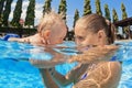 Little baby boy swimming in outdoor pool with mother Royalty Free Stock Photo