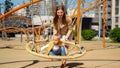 Little baby boy swinging in swing with mother. Children playing outdoor, kids outside, summer holiday and vacation Royalty Free Stock Photo