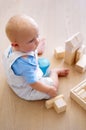 Little baby boy, toys and wooden blocks on floor for playtime, learning or childhood development at home. Cute, adorable Royalty Free Stock Photo